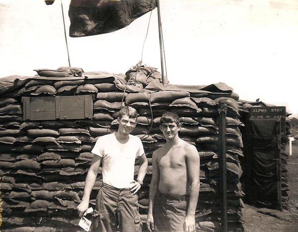 Best Buddies
"FNG" PFC Mike Medley and Sp5 Clint Curry out next to the conex "window" and entry way into the annex.  Must have been a day or two after getting to the battery at St. George since I have on a WHITE tee shirt.  Can't remember even having a green one during my tour, let alone underwear or socks.  Note that the sign reads "A" Battery in the background.
