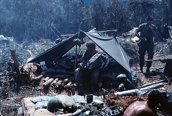 Combat Camping 101
Now this is the roper way to fix camp bedding.  A couple layers of sandbags over some cut poles topped with an air mattress.  You hope you get a least a week in place to enjoy it.
