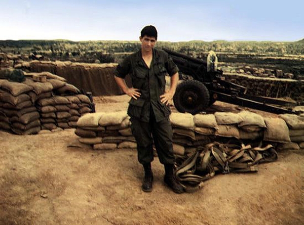 Just landed
Hi, Mom!  I'm here.  I'm at LZ Baldy.  Joe Henderson stands in a clean uniform next to the cargo straps that carried the 105mm howitzer into position.
