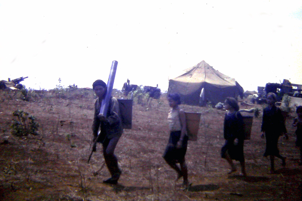 It's mine now!
A civilian swipes a stovepipe and carries it away.

Occasionally, a firebase position would be close to civilian villages.  Note the howitzer at top left.
