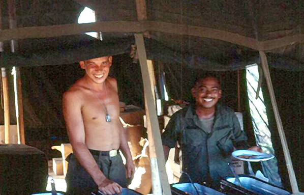 Chow Time
PFC Alvin Hite, Cook and SFC Frank Venegas, Chief of Smoke,  enjoy a "hot meal" from the mermite cans at LZ OD, firebase for 1/35th and "A" Battery.

SFC Venegas eventually became the Command Sergeant Major of III Corps Artillery located at Ft. Sill, Ok where he resided until his death.
