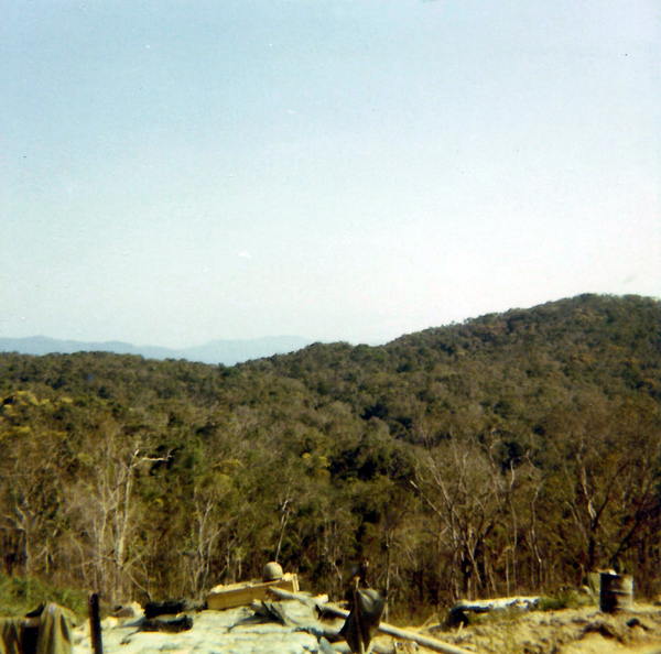 LZ Tuffy - 1970
Million dollar views from Tuffy - this slide and next.   Unless, of course, you looked 1800 mils and saw the ridgeline lurking over the firebase. It was a mother to try to hump trunks up the steep sides of those hills to use for overhead cover.  The mountaintop was so small and steep that we could only fire the full battery (I think we were still down a tube at that time) on high angle.  {continued next slide}
