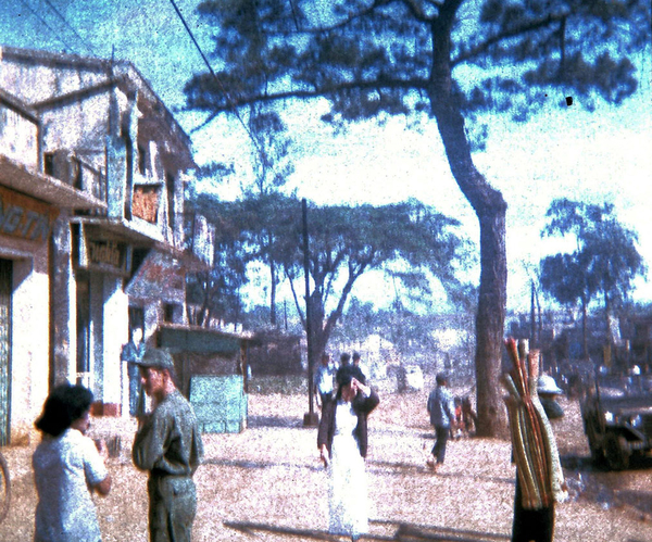 Pleiku series
Looking down the street in Pleiku.  Notice the girl in the Ao Dai (dress).  As she saw me starting to take the picture, she covered her face.  I think this has something to do with the belief that the picture would take their soul.  {Webmaster: Yes...this happened a lot}
