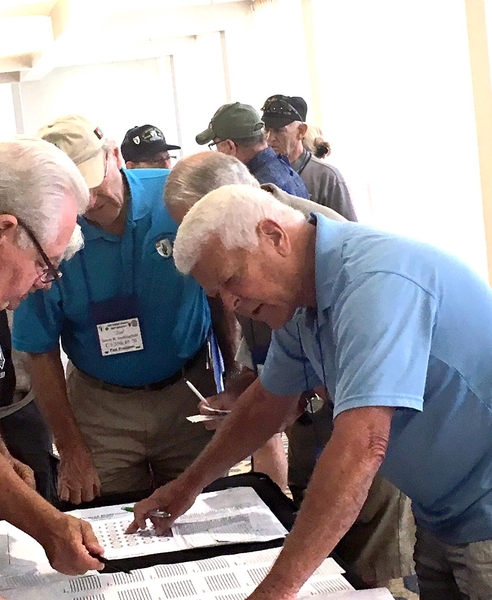 The Normandy Invasion strategy session?
No, it just looks like it.  Ed Thomas reviews the seating selection chart for the Saturday night banquet.  This has been an annual ritual, oftentimes contentious, on where we sit.
