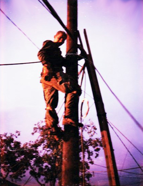 After Mother's Day Attack
Steven Cox at the Oasis, climbing the pole to make repairs.
