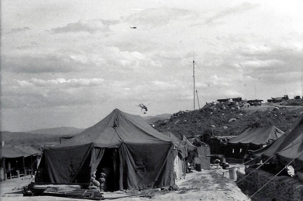 Our Survey Hooch at LZ Montezuma
Our tented headquarters for the surveyors.  Note the slick flying high above the Sikorsky Sky Crane in the background.  Carrying a water trailer for a Sky Crane is a very light load for it.
