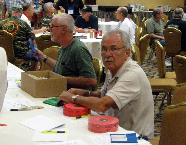 "You want HOW many???
Terry Savely mans the Registration Table offering raffle tickets for sale.  The 50/50 drawing split this year was $1,100, a nice, tidy sum to the winner.  And, the winner was Ms Linda Curtis, guest of 2/9th Redleg Mike Kurtgis.  She donated the winnings back to the 35th in memory of Lt Roger Fulkerson, an FO from the 2/9th serving with the 35th in the field.  Roger was the best friend of Mike Kurtgis.  Fulkerson was KIA in a firefight.
