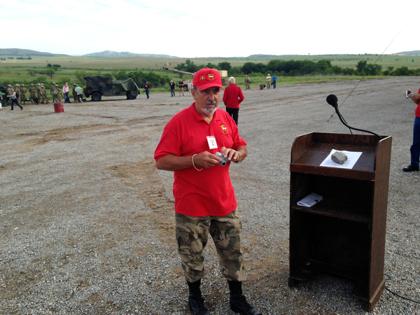 Thursday Firepower Demonstration
Webmaster Dennis Dauphin takes a peek at the script for the Firepower Demonstration.

Photo courtesy of William Ward.
